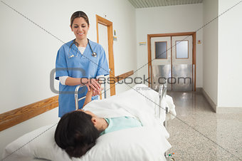 Female patient holding the hand of a nurse