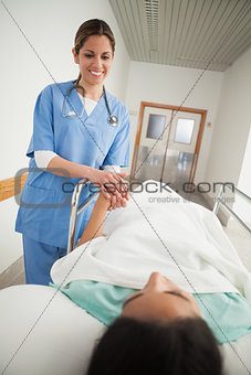 Nurse holding hand of a female patient