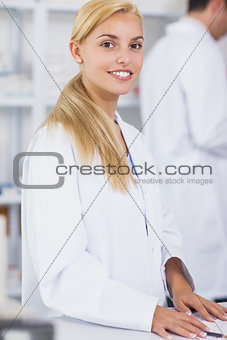 Blonde pharmacist looking at camera