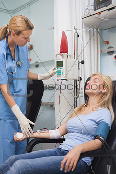 Nurse checking a monitor next to a donor