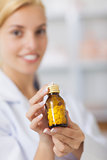 Pharmacist showing a drug bottle