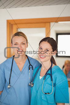 Female nurse and intern looking at camera