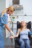 Nurse taking the pulse of a blood donor
