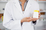 Close up of a pharmacist presenting a drug box
