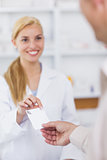 Patient giving a prescription to a pharmacist