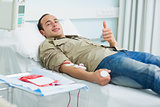Smiling transfused patient lying on a bed