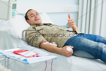 Smiling transfused patient lying on a bed