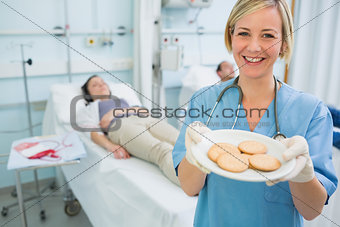Nurse holding a plate of biscuits