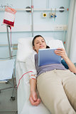 Female transfused patient holding a tablet computer