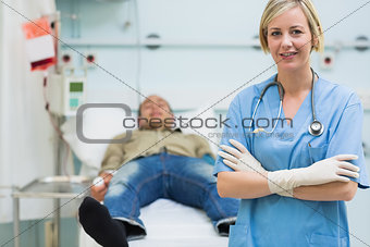 Nurse next to a male patient with arms crossed