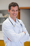 Smiling doctor with arms crossed