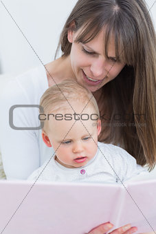 Mother reading a book to a baby
