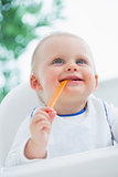 Baby biting a plastic spoon