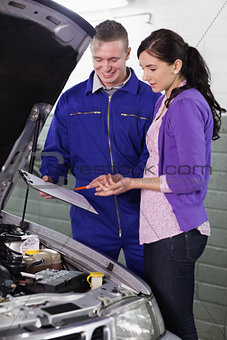 Mechanic standing next to a client
