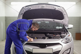 Mechanic looking at an engine