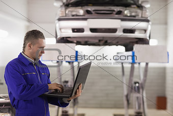 Mechanic holding a laptop