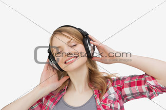 Woman closing eyes while listening music