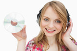 Woman smiling while holding a cd