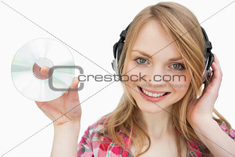 Woman smiling while holding a cd