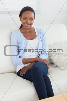 Black woman sitting on a sofa