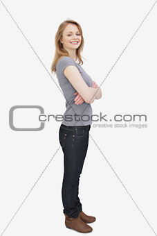 Side view of a woman smiling with arms crossed