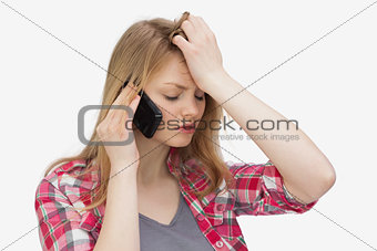 Upset woman holding a mobile phone