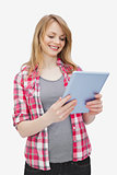 Woman holding a tablet computer while standing