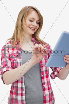Woman touching a tablet computer while looking it