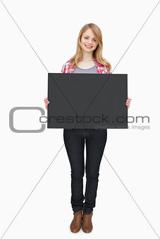 Woman holding a black board