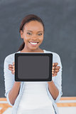 Smiling black woman holding a tablet computer