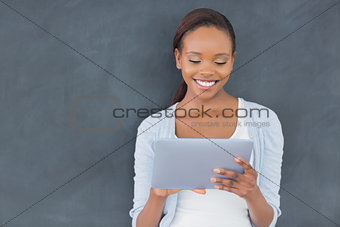 Front view of a black woman holding a tablet computer