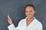 Black woman holding a chalk while smiling