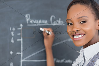 Focus on a teacher drawing a chart on a blackboard