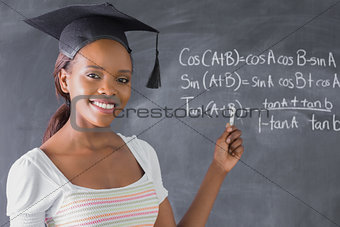 Student smiling while showing the blackboard
