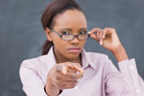 Focus on a strict black teacher pointing finger 