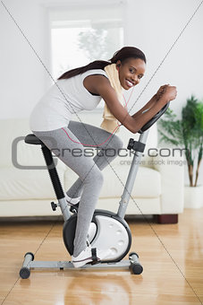 Side view of a concentrated black woman doing sport