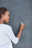 Black woman writing on a blackboard