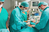 Surgeons operating with surgical tools