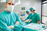Surgeon with arms crossed looking at camera