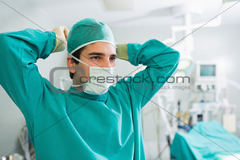 Surgeon attaching his mask
