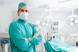 Serious surgeon standing with arms crossed