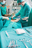 Focus on surgical team next to surgical tools