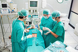High angle view of surgeon operating an uncounscious patient 