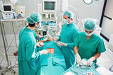 Team of surgeons operating an uncounscious patient