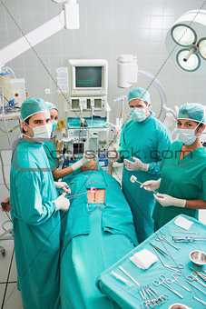 Group of surgeons operating a patient in an operating theater