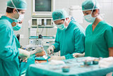 View of a surgical team operating a patient