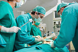 Surgical team looking at a patient