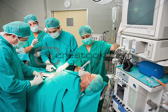 Surgical team operating a patient belly