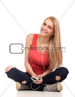 Blond teenage girl sitting and listen music