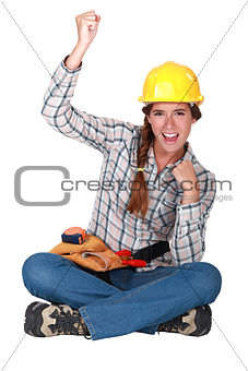 Female builder raising fist
